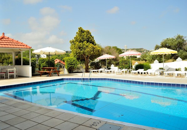 Utomhuspool, parasoller och solstolar