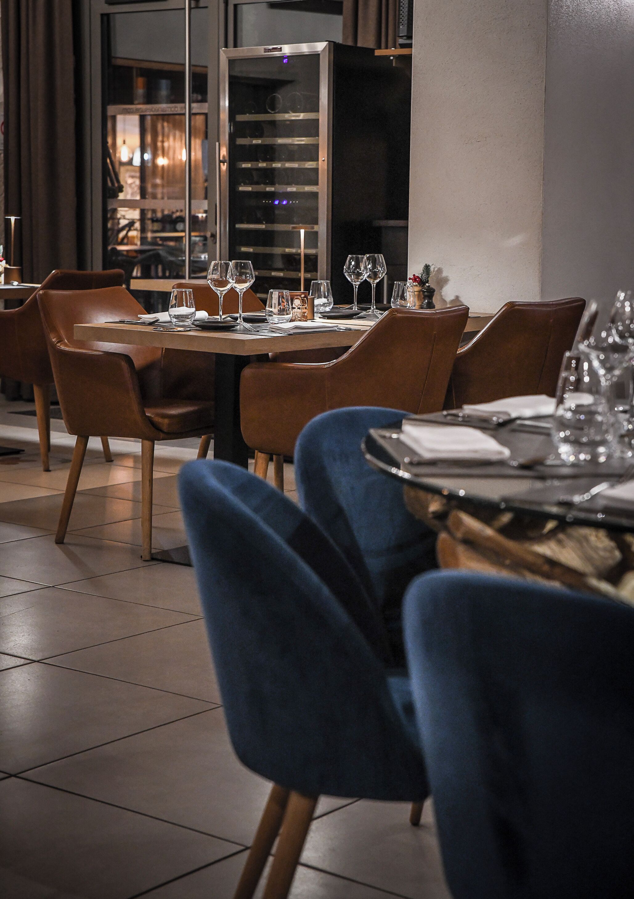 A dining area with a table set for four, including wine glasses and plates.