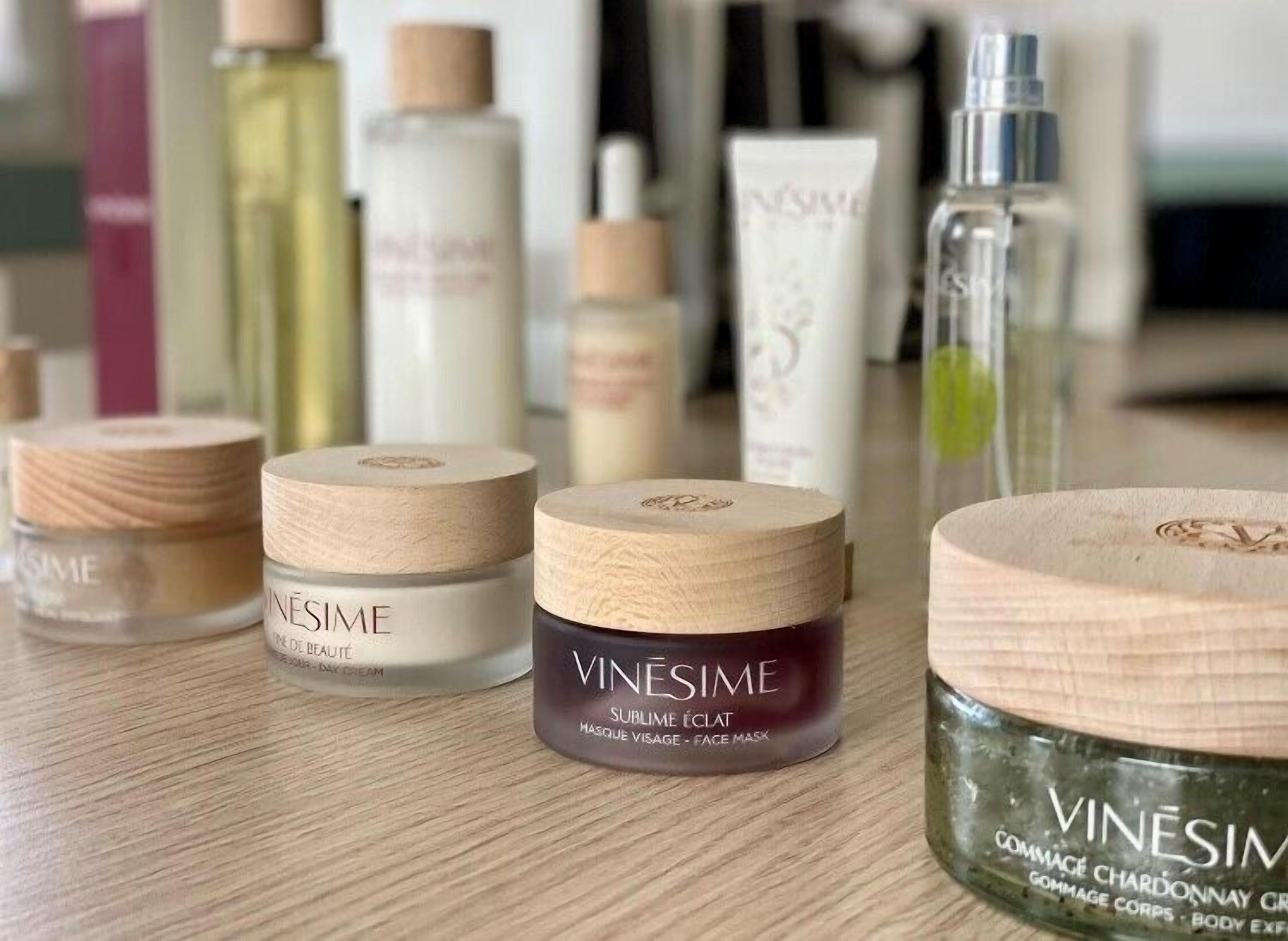 A variety of skincare products with wooden lids, including a face mask and a body cream.