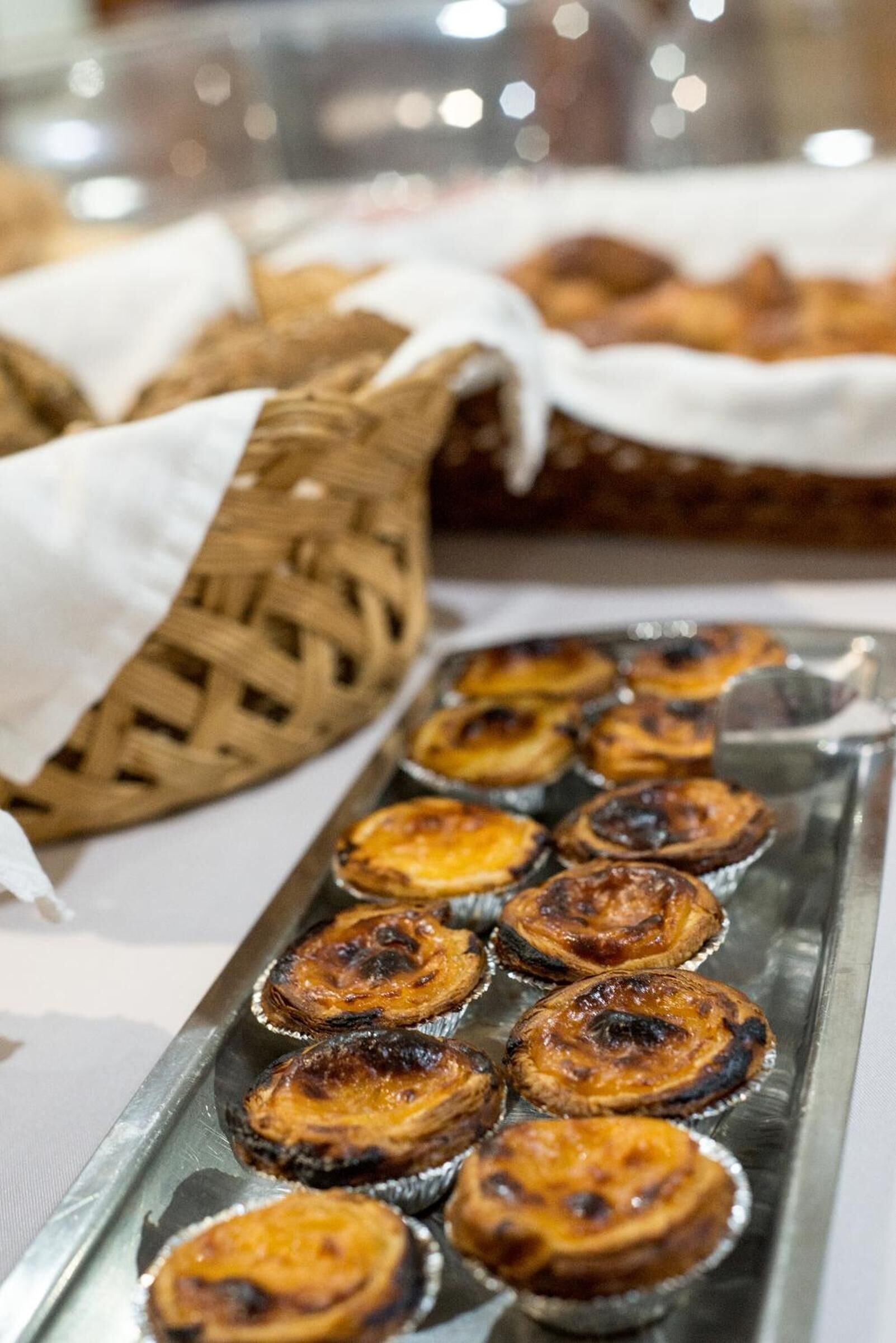 A tray of Portuguese egg tarts on a table.