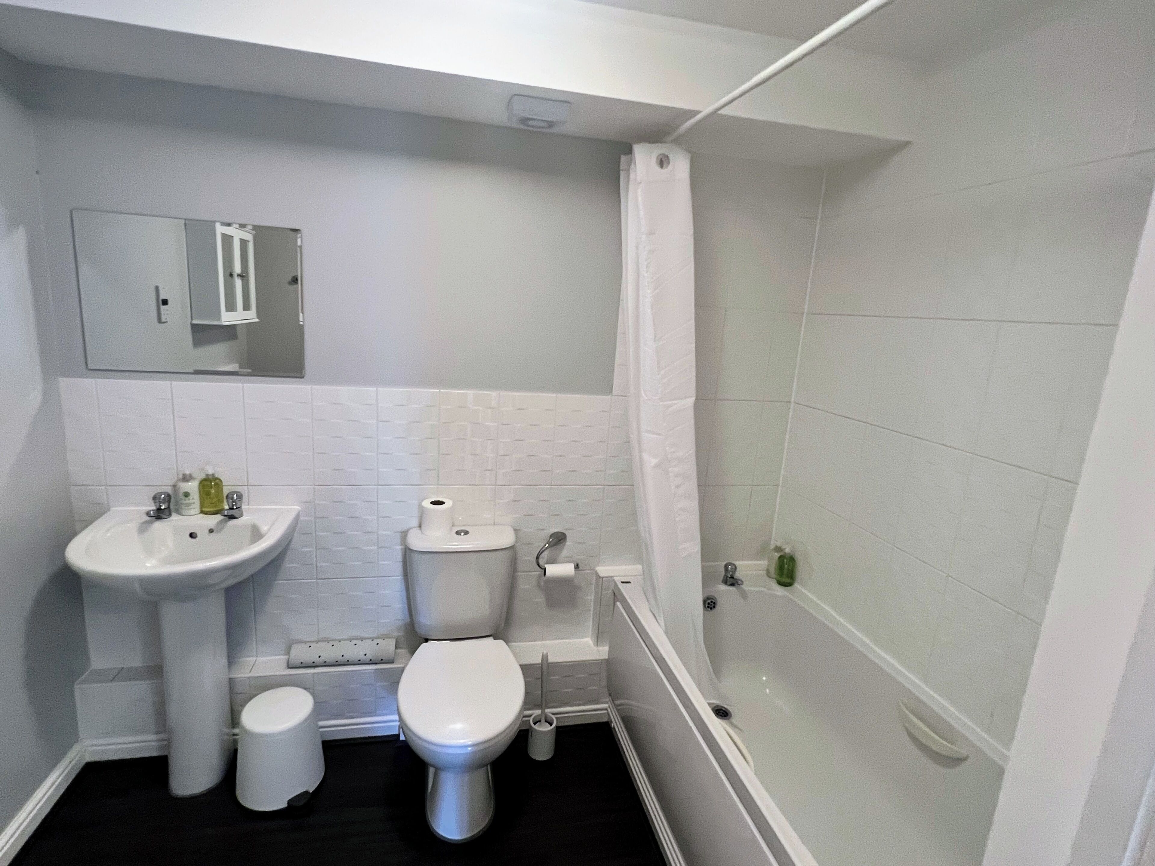 A bathroom with a sink, toilet, and bathtub.
