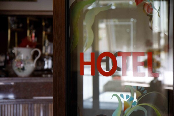 A hotel sign with the word "HOTEL" in red letters.