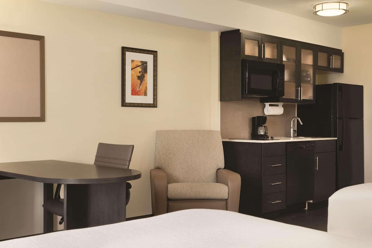 pillow-top beds, desk, laptop workspace, blackout curtains