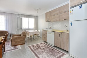 A modern kitchen with wooden cabinets, a built-in dishwasher, and a refrigerator.