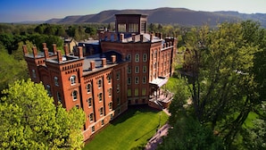 A large brick building with multiple towers and a central courtyard. - Courtyard by Marriott Elmira Horseheads (Horseheads)