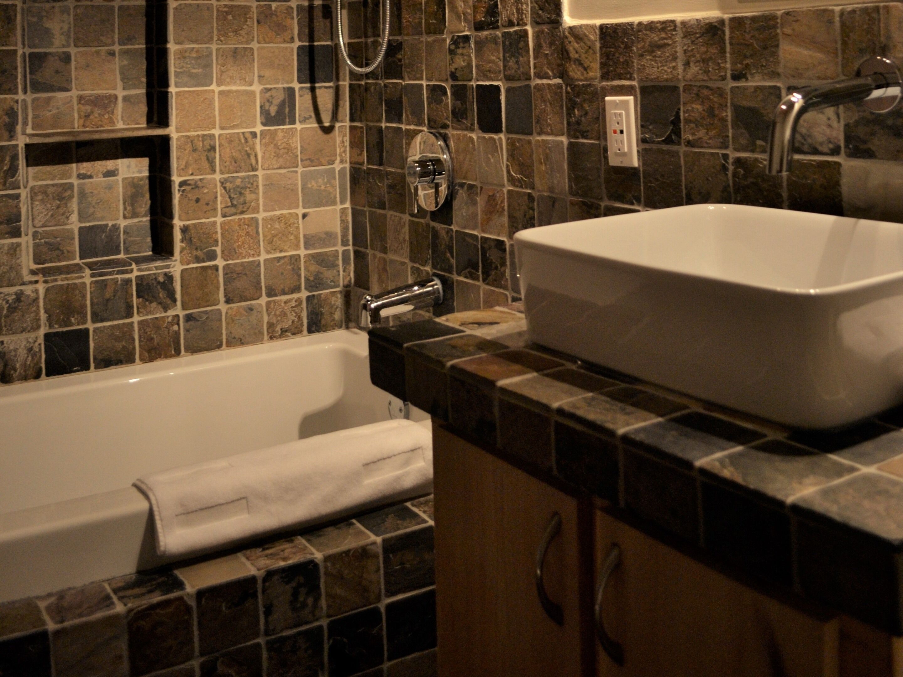 A bathroom with a bathtub, a sink, and a shower.