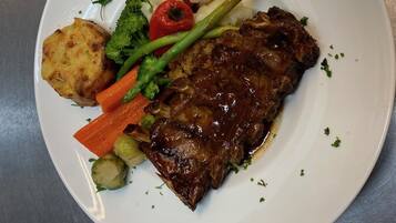 A plate with a steak, potatoes, carrots, and broccoli.