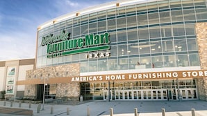A furniture store with a large glass facade and a sign reading "Nebraska Furniture Mart Texas". - Hilton Garden Inn The Colony Dallas (The Colony)