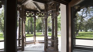 A covered pavilion with a tiled floor and wooden columns. - Pałac Polanka (Krosno)