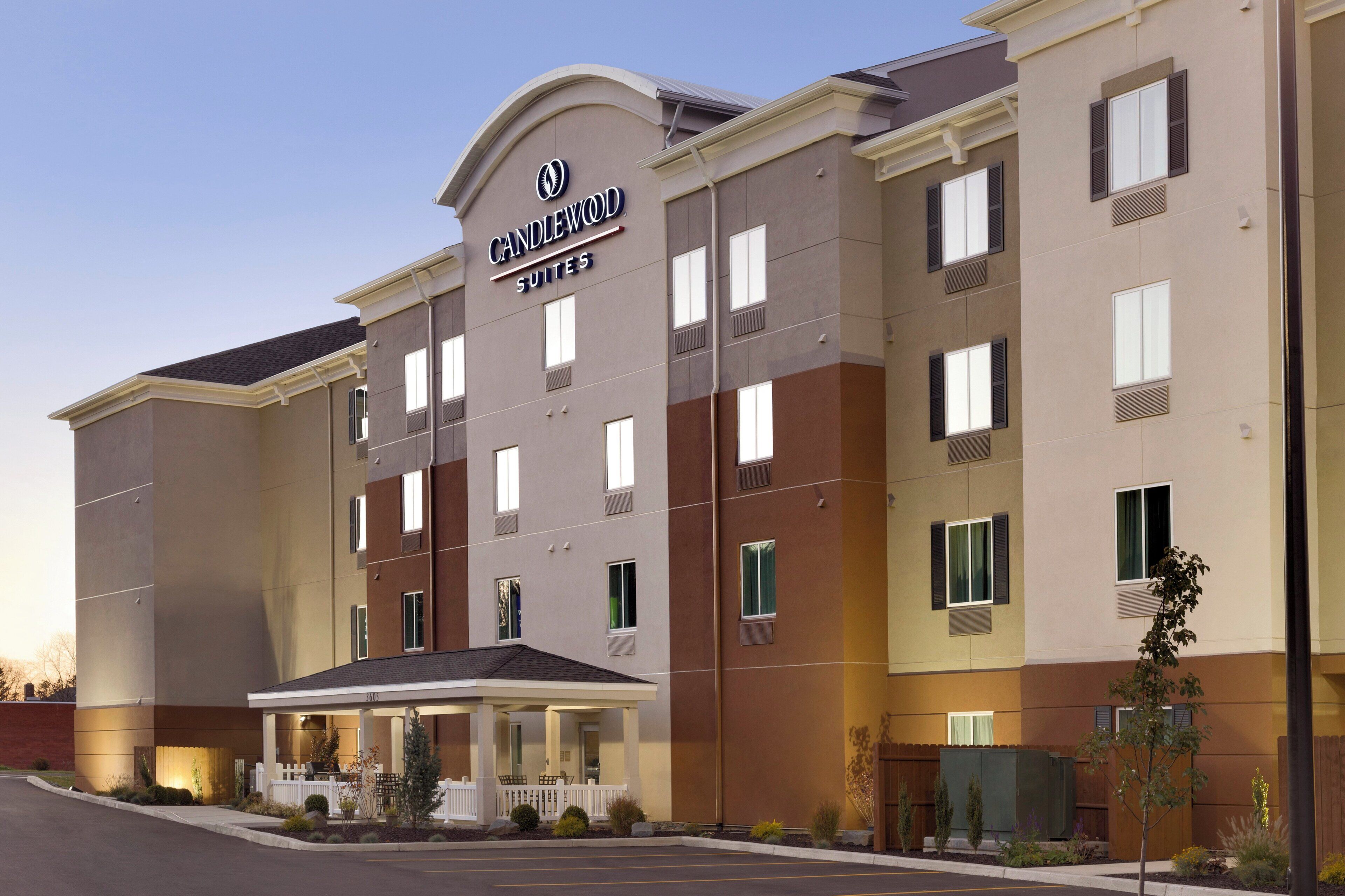 A multi-story hotel with a prominent sign reading 'CANDLEWOOD SUITES'.