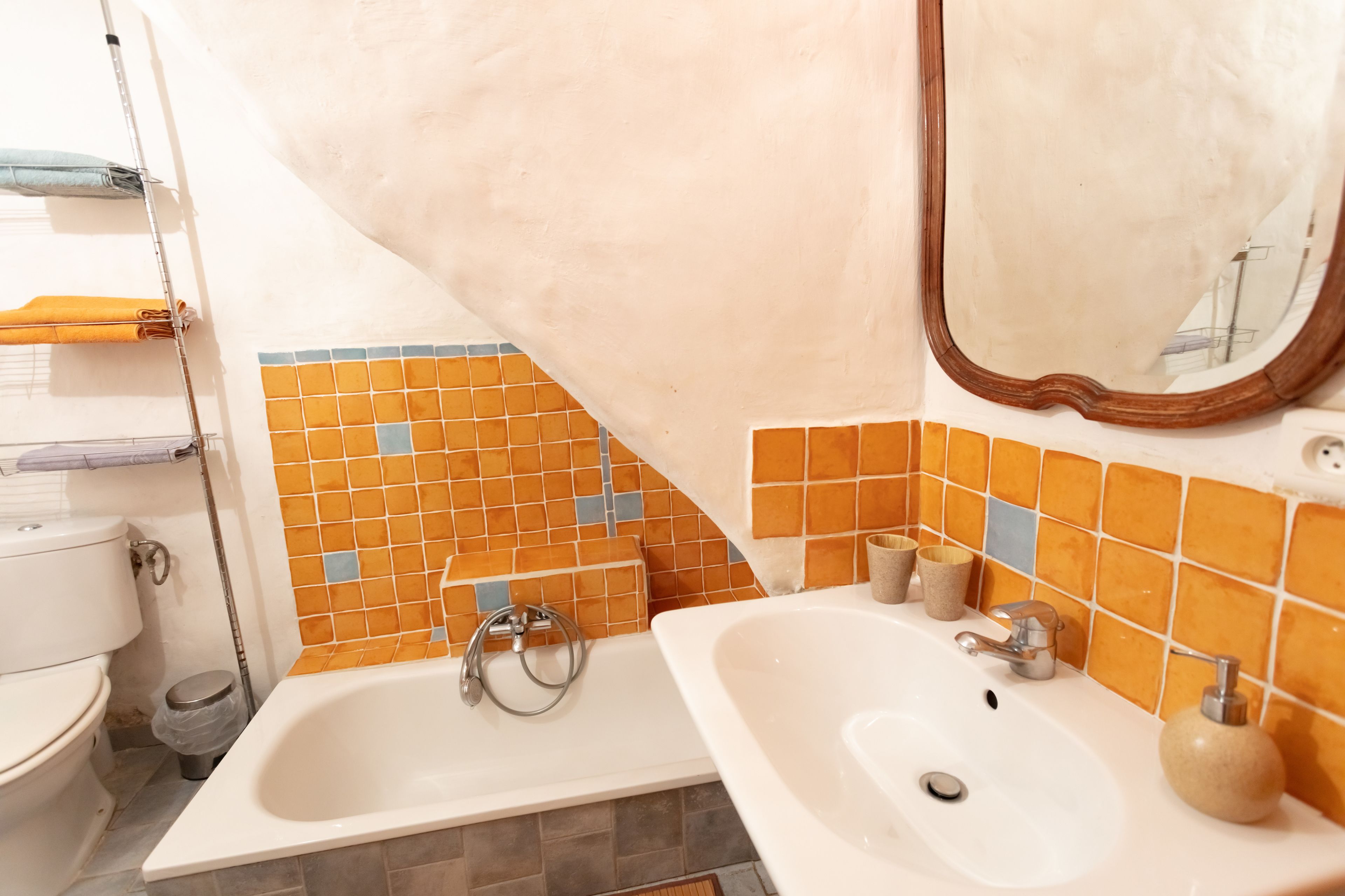 A bathroom with two sinks, a toilet, and a shower.