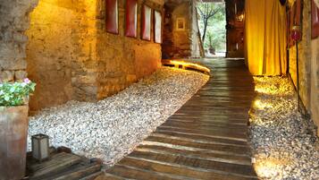 A stone tunnel with a wooden pathway leading through it.