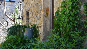 A stone building with a sign reading "La Vieille Maison" indicating a historical property.