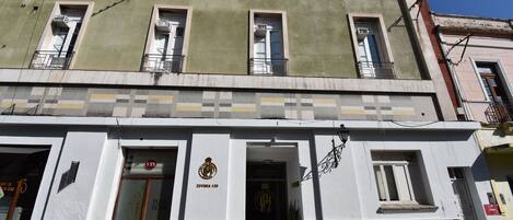A building with a sign reading "ZURBIA 135" and a logo above the entrance.