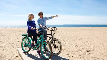 Cyclists enjoy leisurely rides on this expansive beach with scenic views.