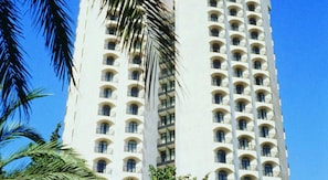 A tall white building with multiple balconies and arched windows. - Vert Jerusalem (Jerusalem)