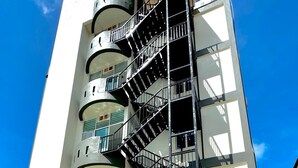 A multi-story hotel with a pool area, featuring a modern design with balconies and a central staircase. - Royal Agate Beach Resort (Langkawi)