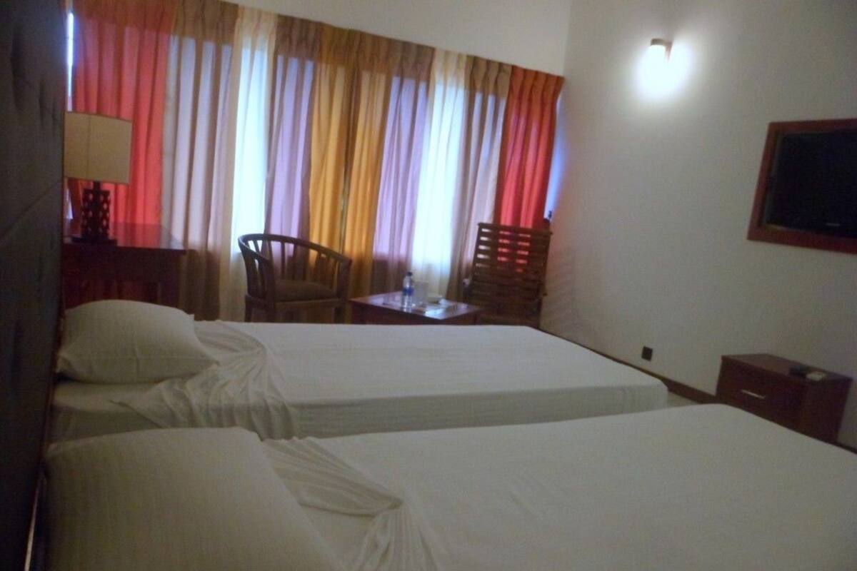 Premium Room, Courtyard View Triple Room | Living room | Flat-screen TV, fireplace