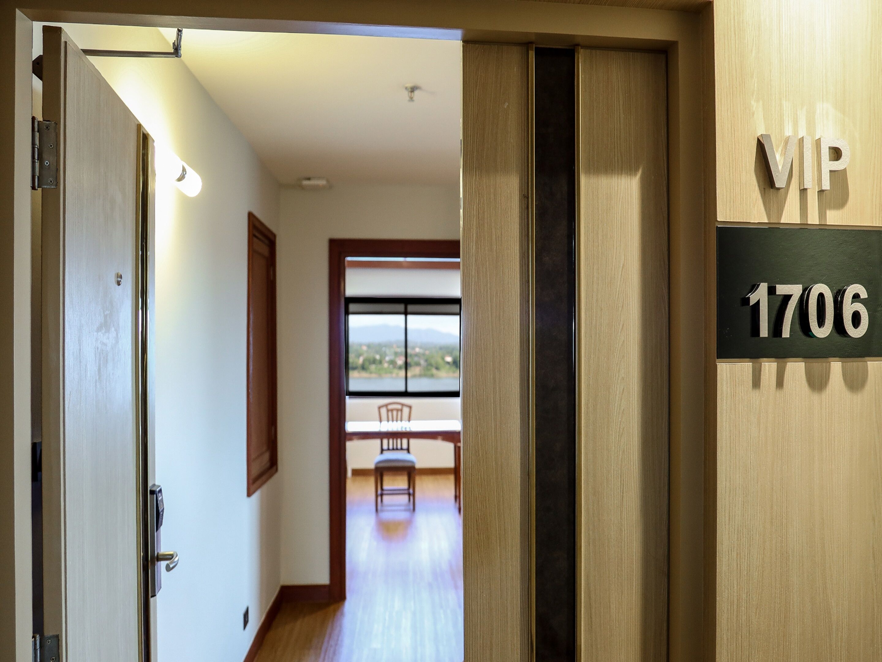 A hotel entrance with a sliding door labeled "VIP 1706".