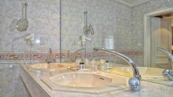 A bathroom with two sinks, a large mirror, and a towel rack.