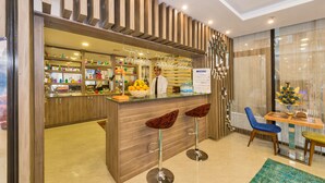 A modern bar area with wooden accents, a menu board, and bar stools. - Grand Palace Hotel (Istanbul)