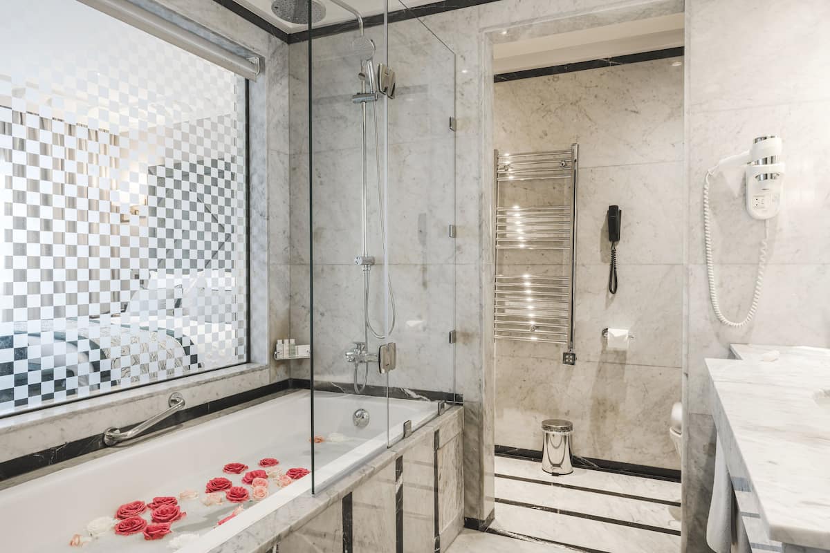 superior double room with pool & garden view | bathroom | designer toiletries, hair dryer, bathrobes, slippers