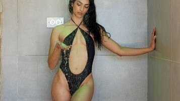 Una persona en traje de baño de pie en una habitación con una pared lisa y un interruptor de luz.