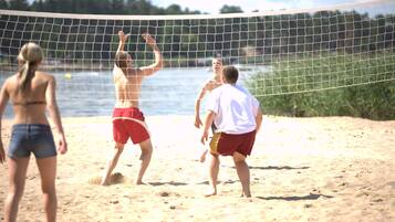 Guests can enjoy a game of beach volleyball with a stunning ocean view.