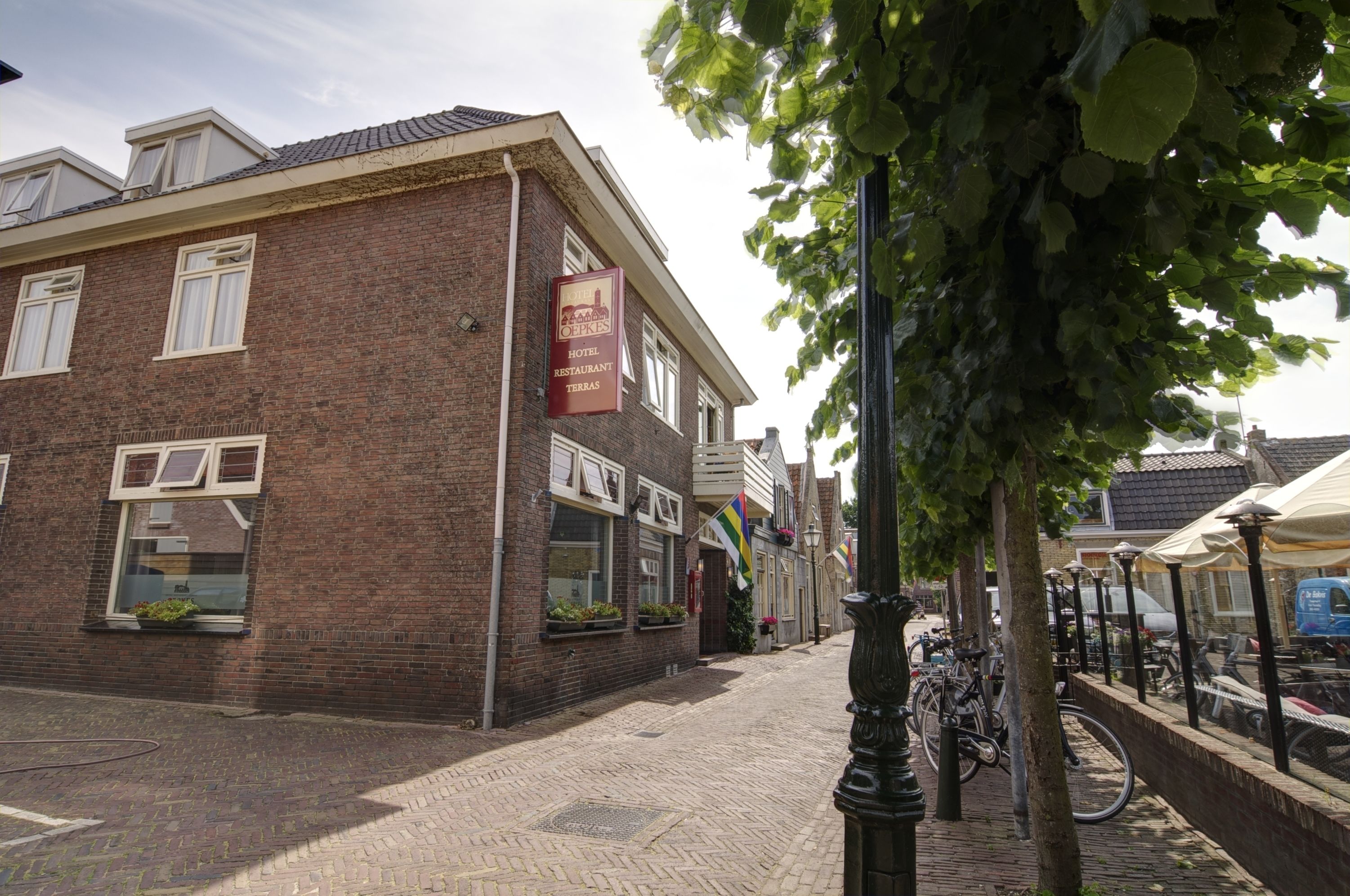 A brick building with a sign for a hotel and restaurant.