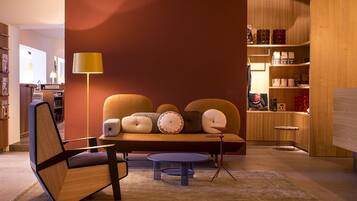 A modern living room with a sofa, a round coffee table, and a floor lamp.
