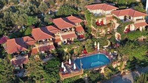 An aerial view of a resort with multiple buildings, a swimming pool, and lush greenery. - Fidanka Hotel (Kas)