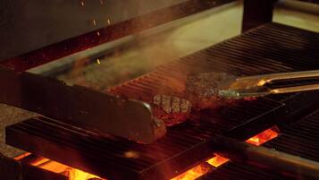 A grill with meat being cooked over an open flame.