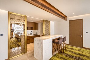 A modern kitchen with a marble countertop, wooden cabinets, and a hexagonal decorative partition. - Crowne Plaza Vientiane by IHG (Vientiane)