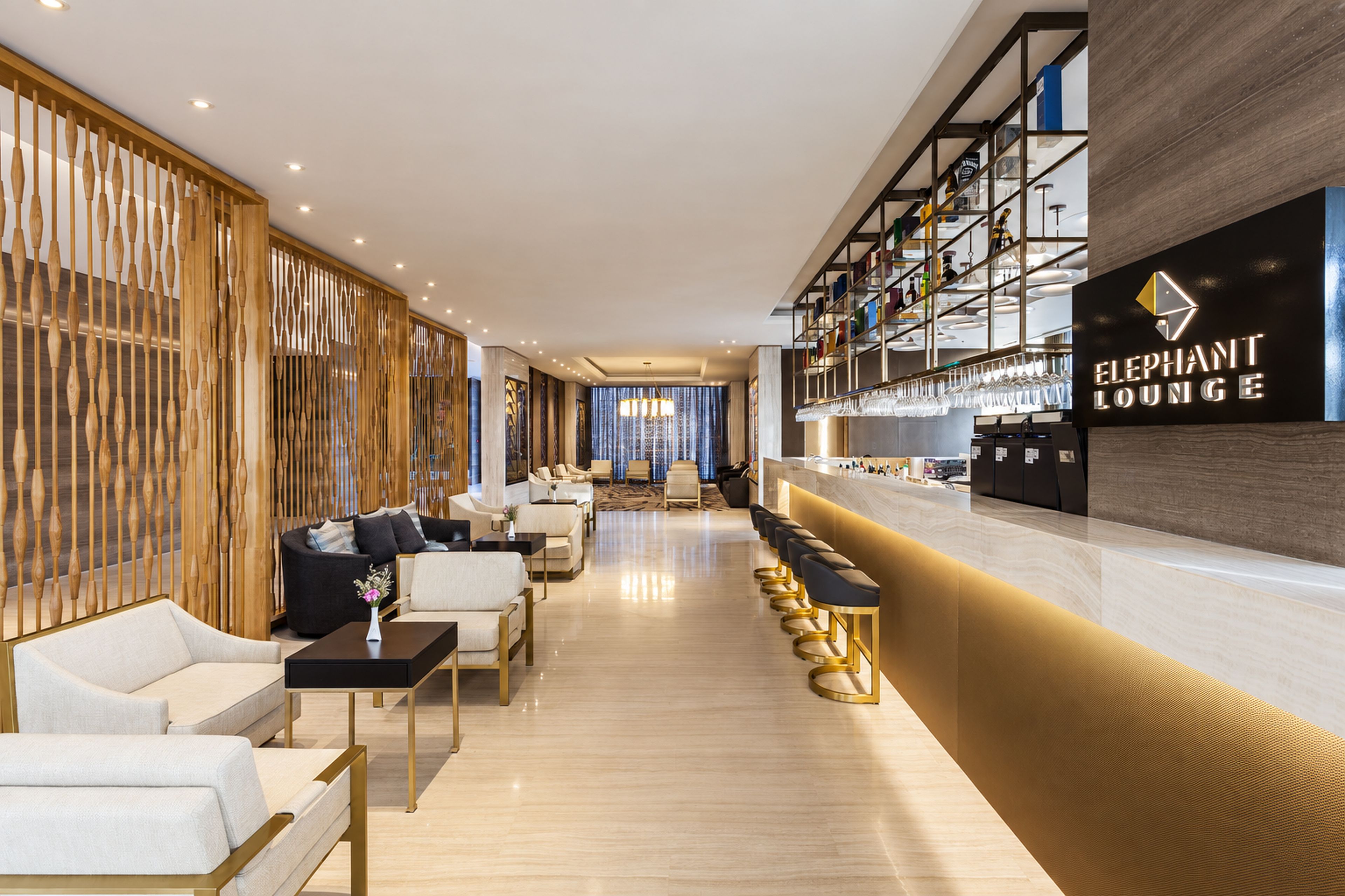 A modern bar area with a bar counter and seating.