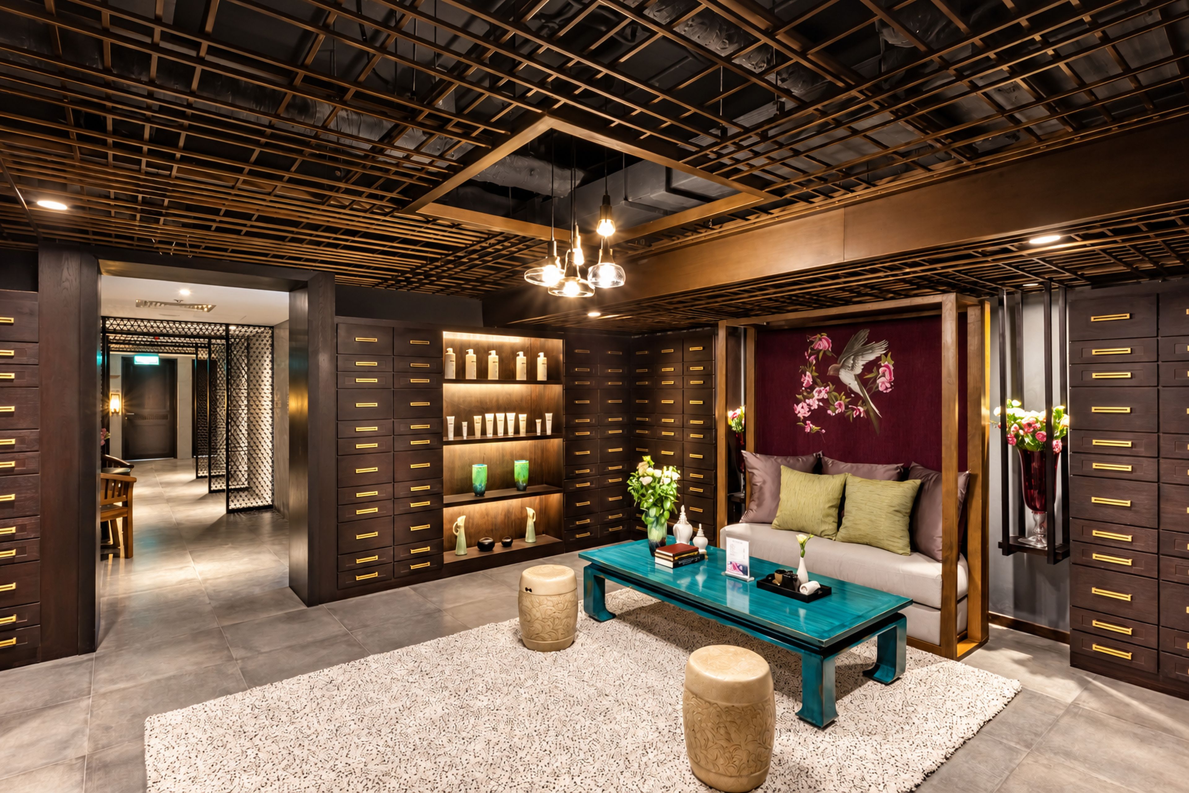 A modern interior with a wooden ceiling, a central coffee table, a sofa, and a decorative wall piece.