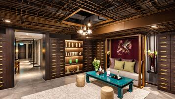 A modern interior with a wooden ceiling, a central coffee table, a sofa, and a decorative wall piece.