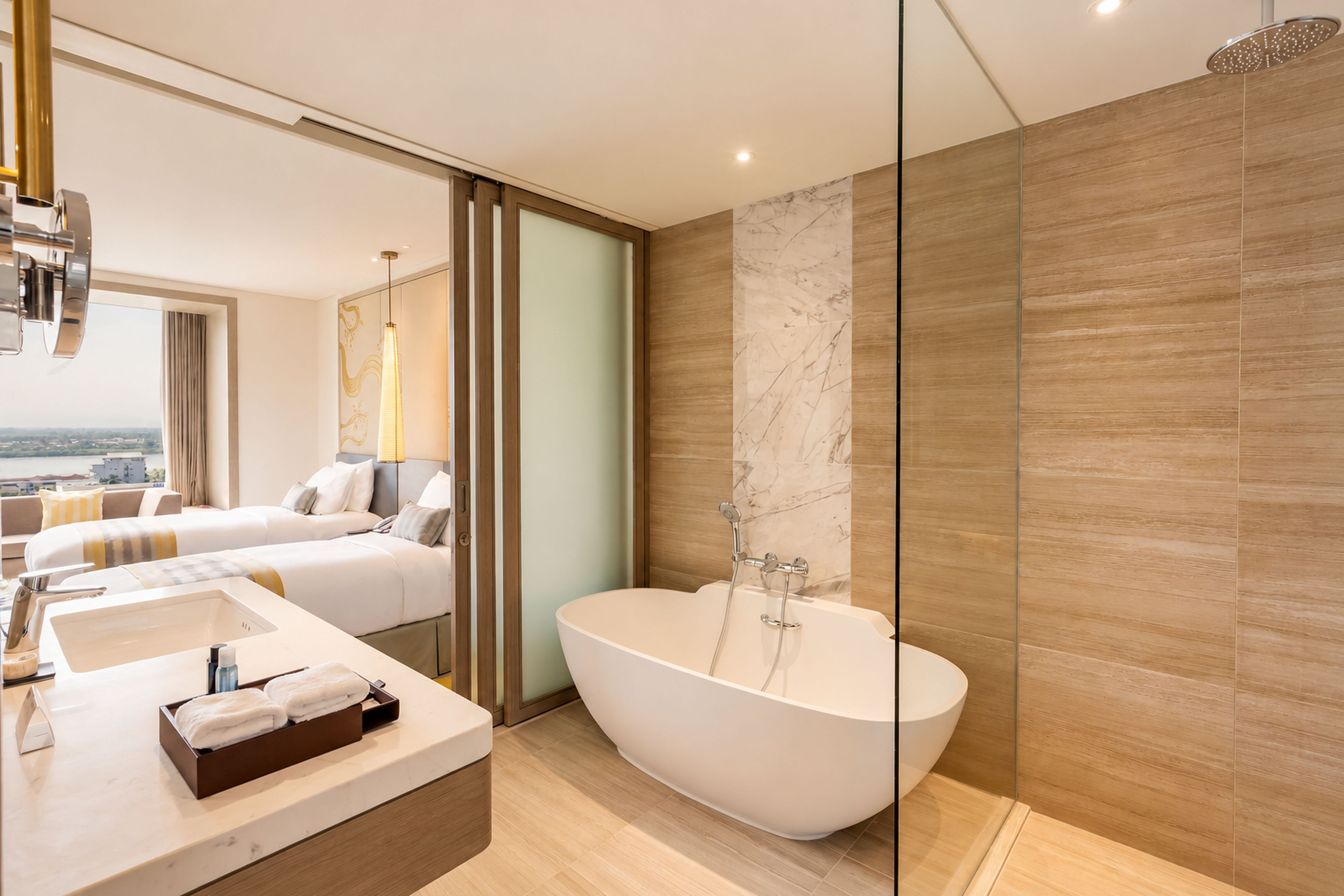 A modern bathroom with a freestanding bathtub, a vanity with a mirror, and a shower area.