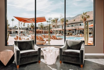 An outdoor bar area with a fire feature and seating. at V Capri Palm Springs, a Dolce by Wyndham