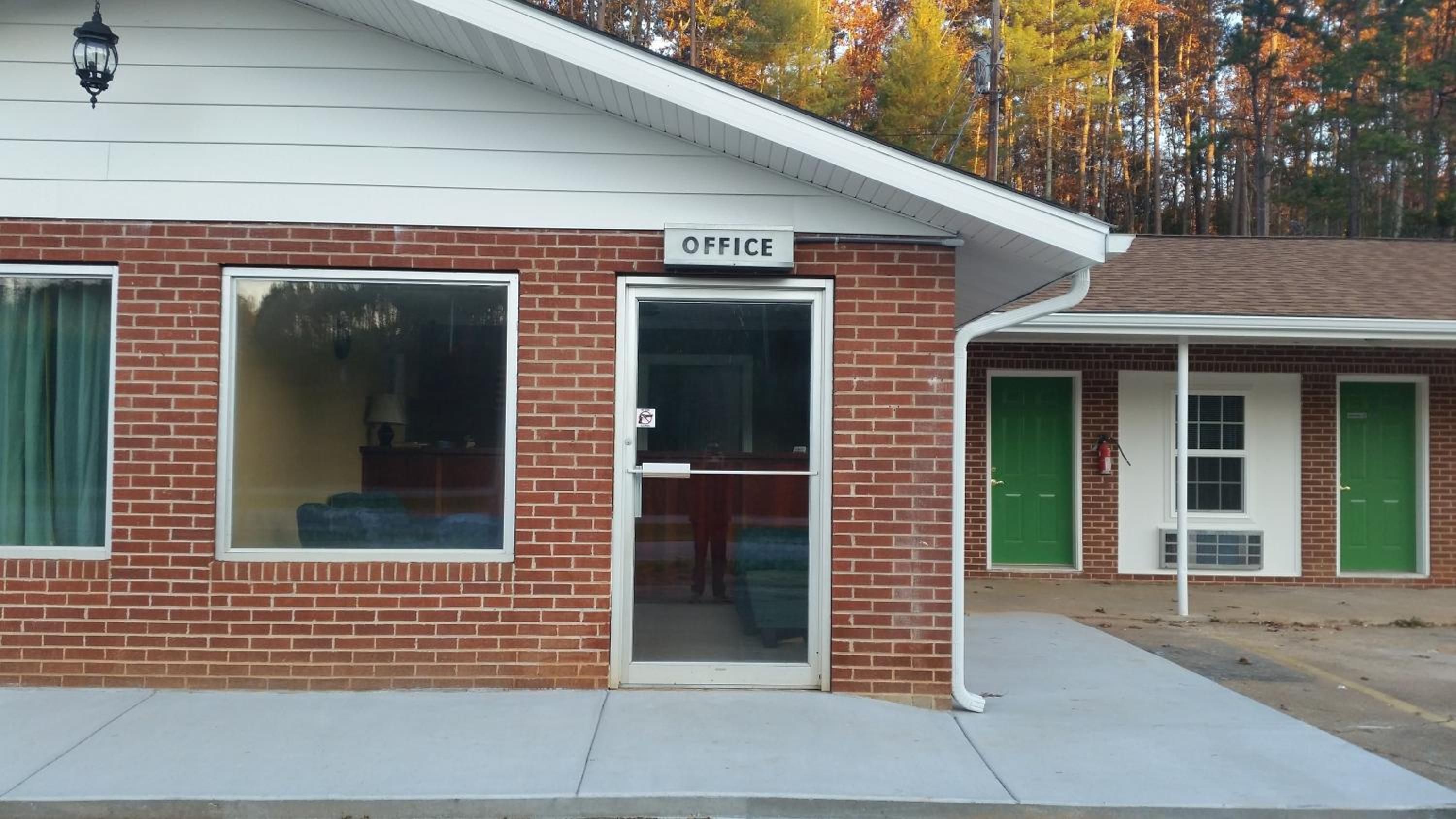 A brick building with a sign reading 'OFFICE' above the entrance.