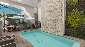 Outdoor pool, open 9:00 AM to 9:00 PM, pool loungers