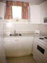 Fridge, microwave, coffee/tea maker, cookware/dishes/utensils