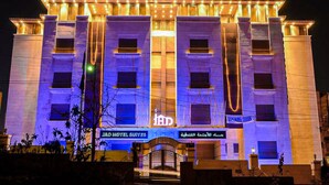 A hotel with a prominent entrance, multiple floors, and a sign indicating it is a hotel. - Jad Hotel Suites (Amman)