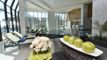 Welcome to our hotel lobby, featuring a spacious reception area with a seating area and large window offering a view of the outdoors.