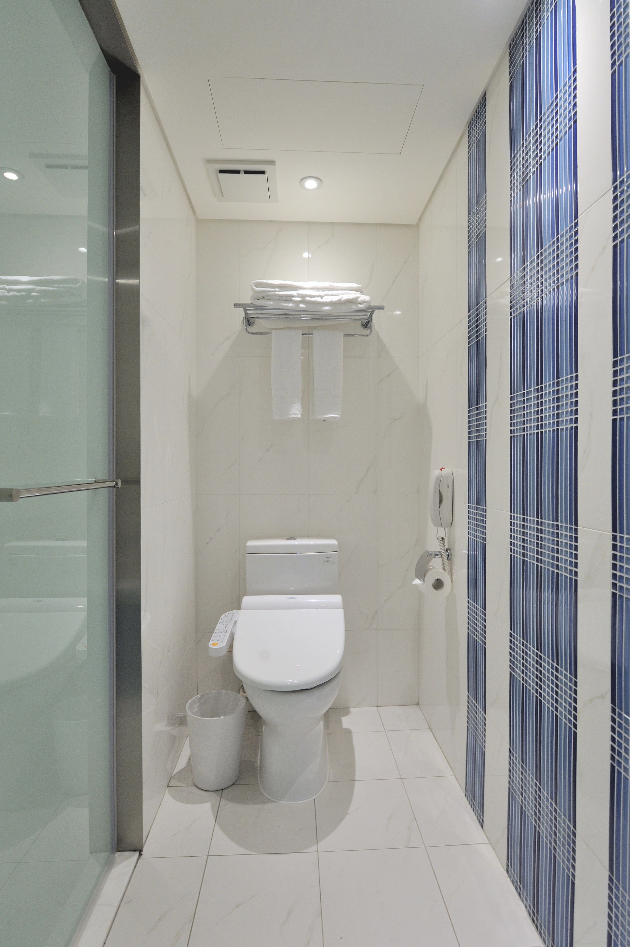 hair dryer, slippers, towels, toilet paper