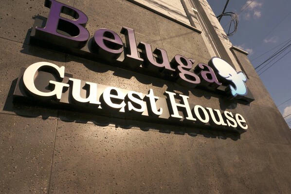 A sign for Beluga Guest House with a stylized elephant logo.