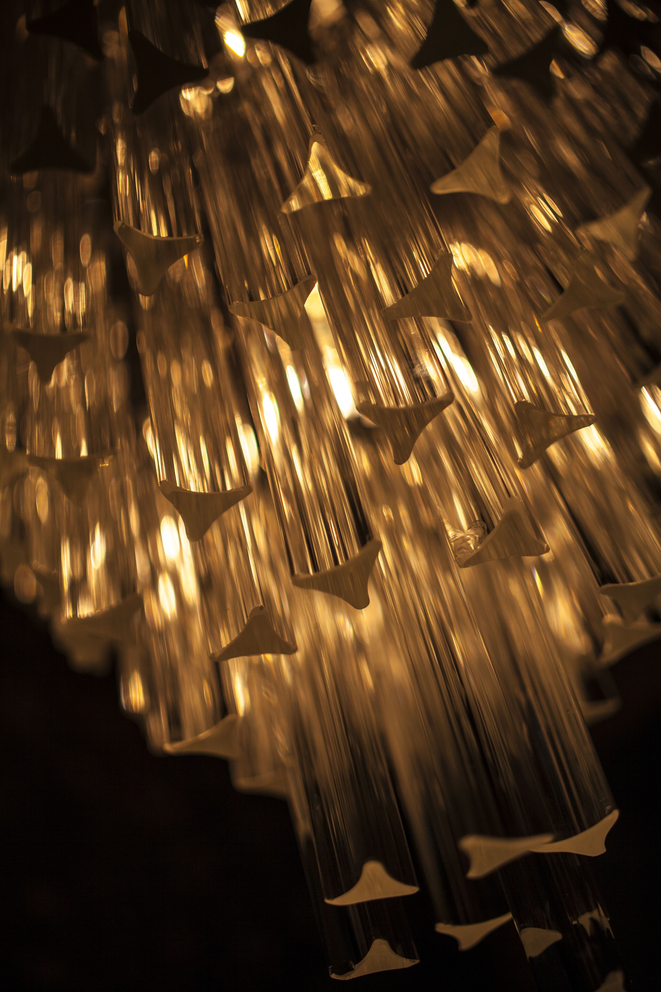A close-up of a metallic, abstract sculpture with geometric shapes and reflective surfaces.