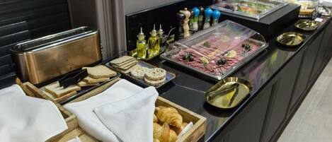 A buffet with various food items and condiments.