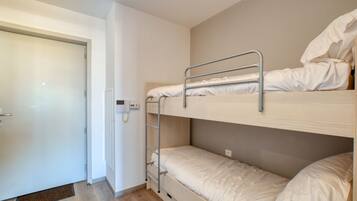 A bunk bed room with a door and a ladder.