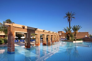 A pool area with clear blue water, lounge chairs, and palm trees. - Valeria Madina Club Resort All Inclusive (Marrakech)