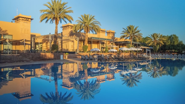A resort with a swimming pool, palm trees, and lounge chairs. - Valeria Dar Atlas Resort All Inclusive (Marrakech)